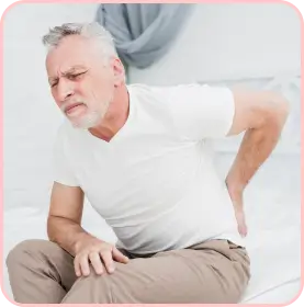 Elderly man in Athens, Georgia, suffering from severe lower back pain, indicating possible herniated disc issues.